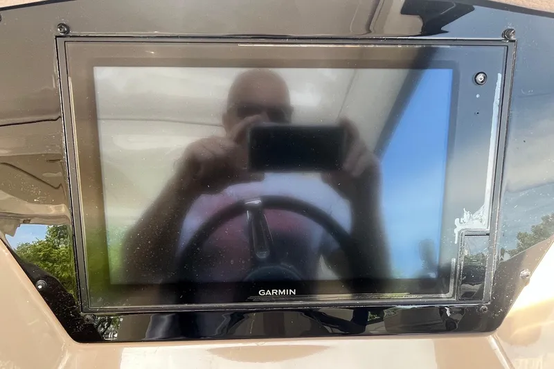 Slide: The Image of Garmin display on 2018 Regal 35 Sport Coupe dashboard, reflecting a person taking a photo. - 34