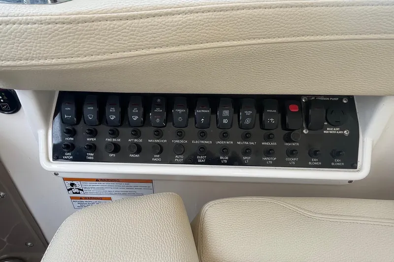 Slide: The Image of Control panel of a 2018 Regal 35 Sport Coupe boat with labeled switches. - 35
