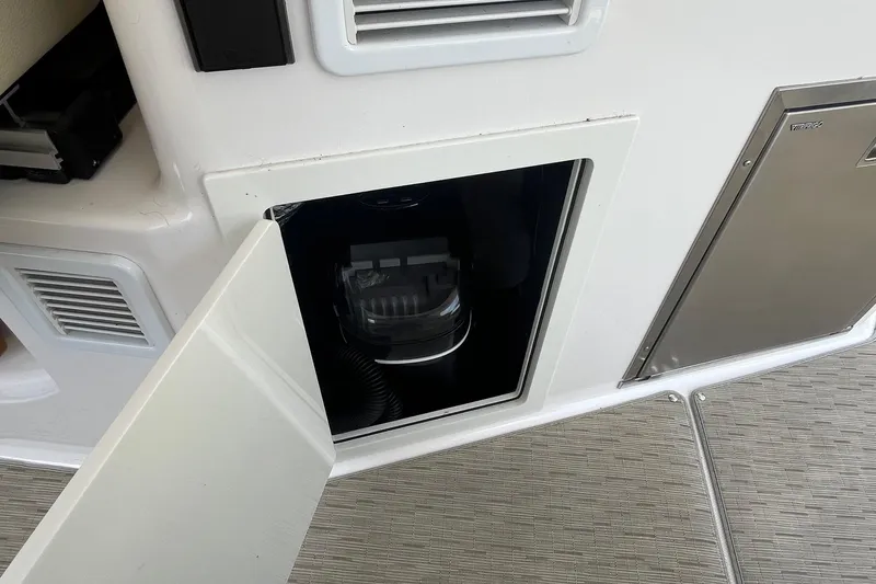 Slide: The Image of Open storage compartment on a 2018 Regal 35 Sport Coupe boat interior. - 36