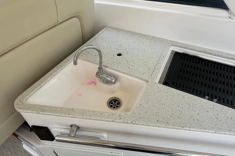 Slide: The Image of 2018 Regal 35 Sport Coupe boat sink and countertop with faucet and grill. - 38