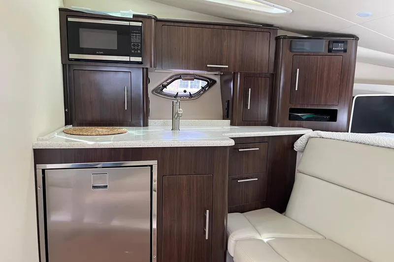 Slide: The Image of Interior of 2018 Regal 35 Sport Coupe yacht with modern kitchenette and seating area. - 40