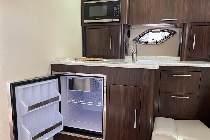 Slide: The Image of Modern kitchen in 2018 Regal 35 Sport Coupe with open fridge, microwave, and sink. - 41