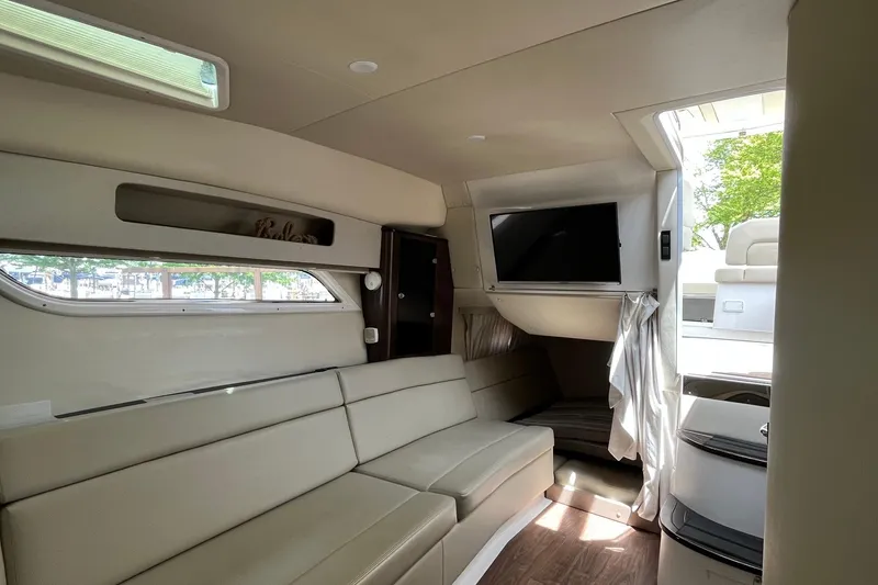 Slide: The Image of Interior of 2018 Regal 35 Sport Coupe with beige seating and mounted TV. - 45