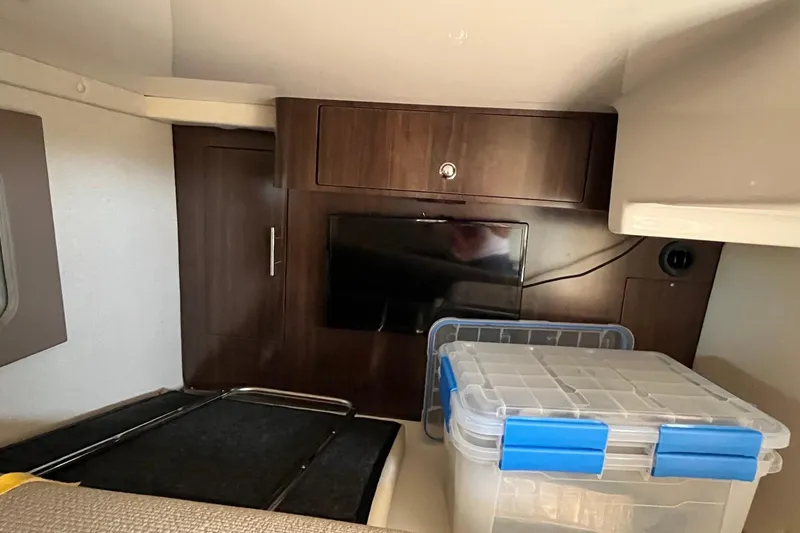 Slide: The Image of 2018 Regal 35 Sport Coupe interior with TV, storage cabinet, and plastic container. - 51