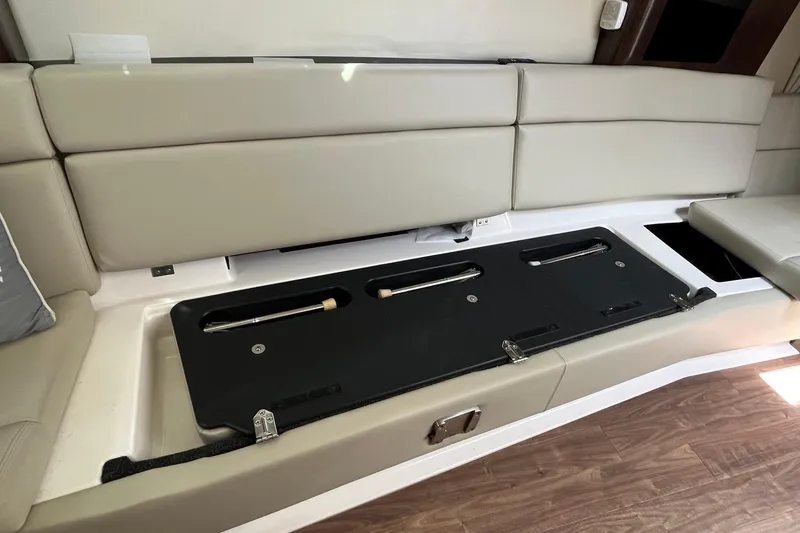 Slide: The Image of 2018 Regal 35 Sport Coupe interior with open storage compartment under beige seating. - 52