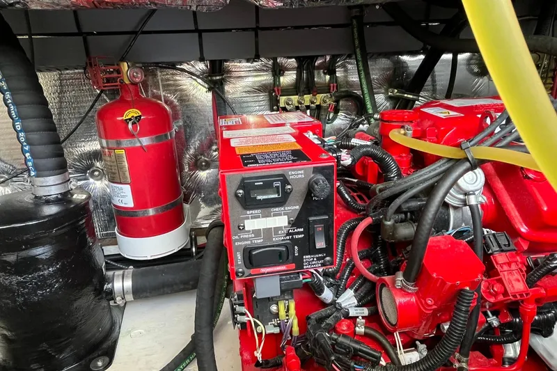 Slide: The Image of Engine compartment of a 2018 Regal 35 Sport Coupe with fire extinguisher and control panel. - 56