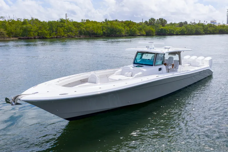 The Image of 2027 HCB 53 Suenos luxury boat on calm water, surrounded by lush greenery. - 0