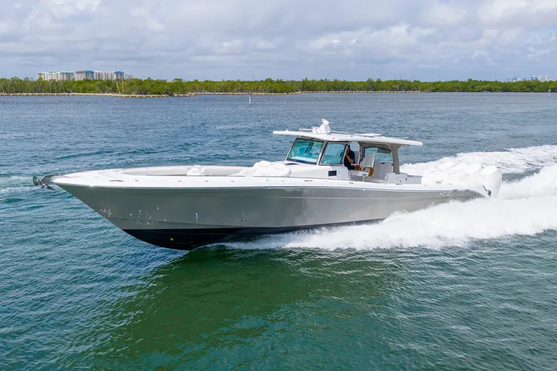 Slide: The Image of 2027 HCB 53 Suenos boat cruising on open water under a cloudy sky. - 11