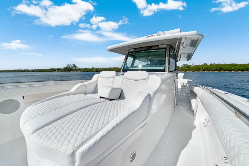 Slide: The Image of Luxurious 2027 HCB 53 Suenos boat with plush seating on a sunny day. - 15