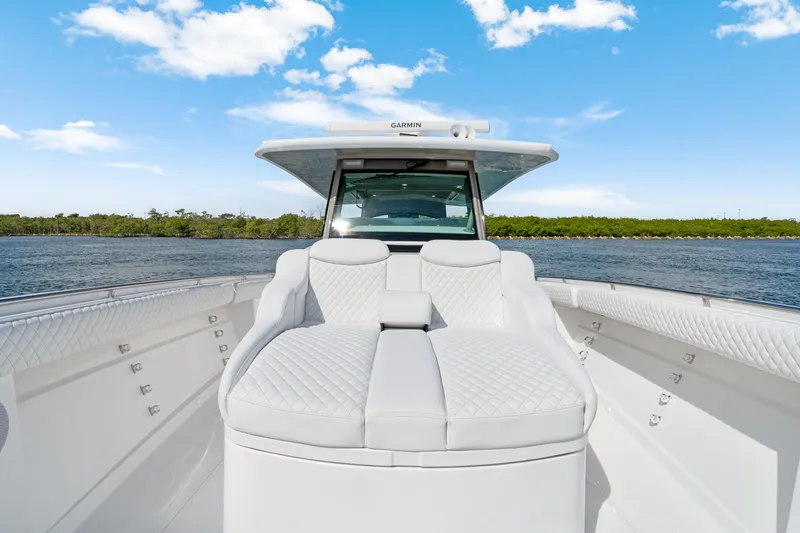 Slide: The Image of Luxurious 2027 HCB 53 Suenos boat interior with plush seating on a sunny day. - 17