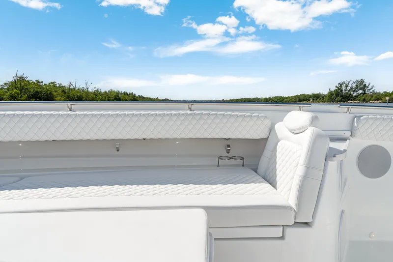 Slide: The Image of Luxurious seating on the 2027 HCB 53 Suenos boat under a clear blue sky. - 18