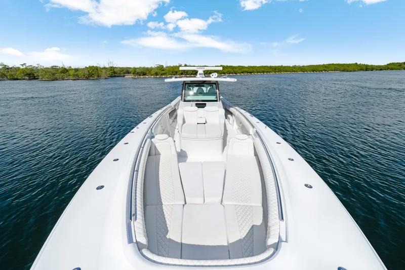 Slide: The Image of Luxurious 2027 HCB 53 Suenos boat on calm water under blue sky. - 19