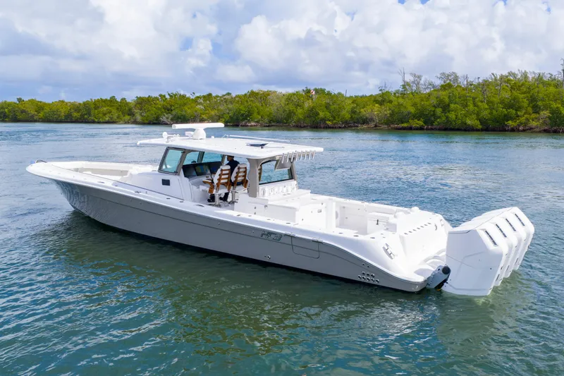 Slide: The Image of 2027 HCB 53 Suenos luxury boat cruising on a serene waterway. - 2