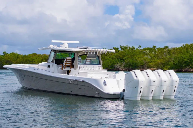 Slide: The Image of 2027 HCB 53 Suenos boat with five powerful engines on a calm waterway. - 3