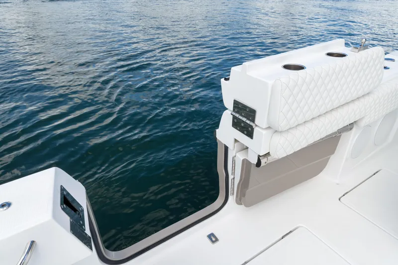 Slide: The Image of Luxury seating on 2027 HCB 53 Suenos boat, overlooking calm water. - 41