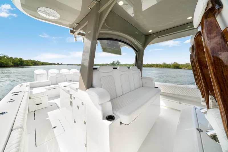 Slide: The Image of Luxurious 2027 HCB 53 Suenos boat interior with plush seating and sleek design on a serene waterway. - 45