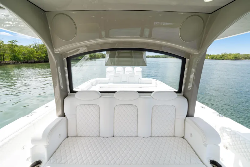 Slide: The Image of Luxurious interior of 2027 HCB 53 Suenos boat with white quilted seating. - 46