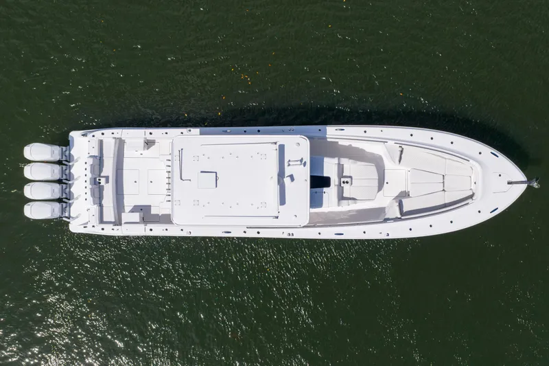 Slide: The Image of Aerial view of 2027 HCB 53 Suenos boat on water, showcasing sleek design and powerful engines. - 5