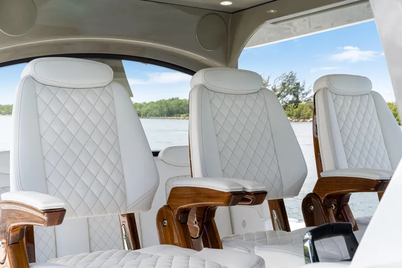 Slide: The Image of Luxurious white leather seats on 2027 HCB 53 Suenos boat, featuring elegant diamond stitching. - 51