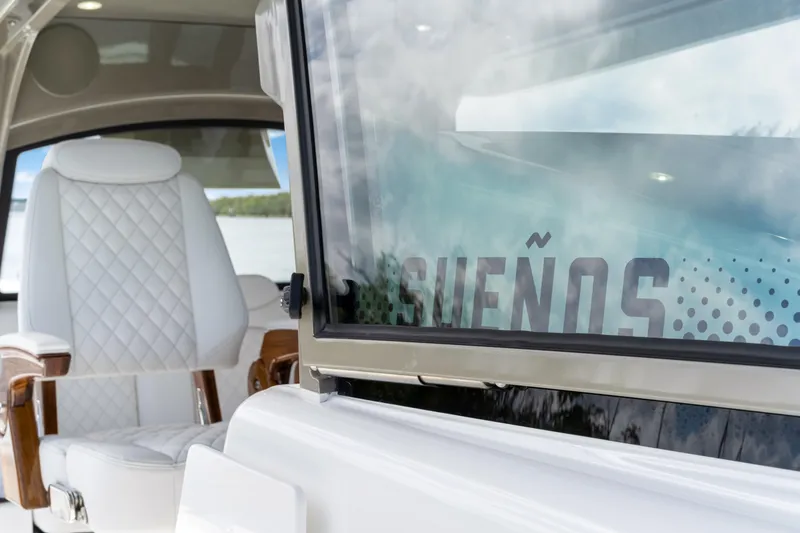 Slide: The Image of Luxury interior of 2027 HCB 53 Suenos boat with white seating and sleek design. - 52