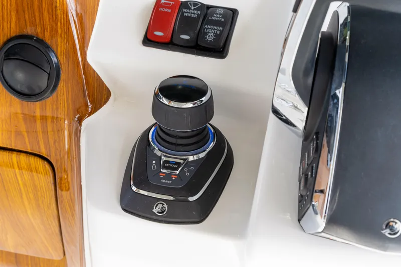 Slide: The Image of Joystick control panel on 2027 HCB 53 Suenos boat, featuring navigation and anchor controls. - 54