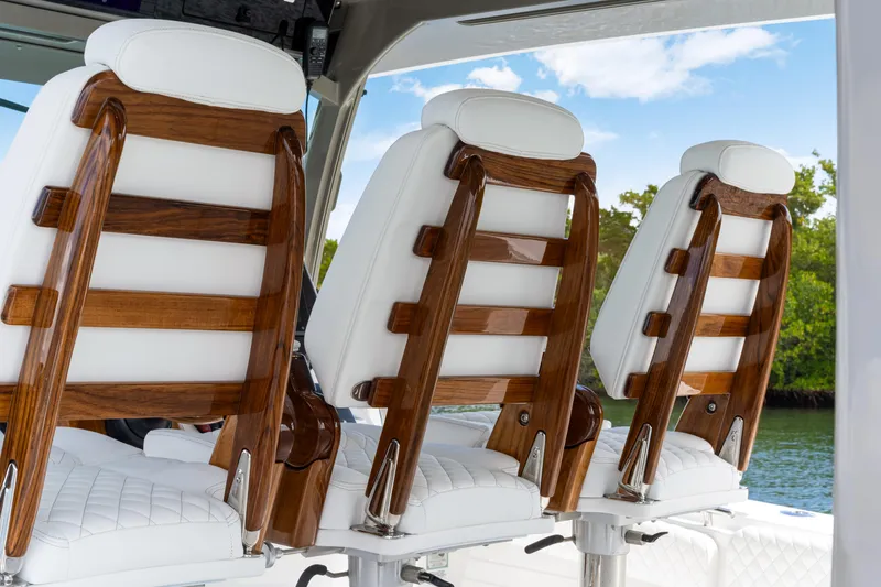 Slide: The Image of Luxurious seating on the 2027 HCB 53 Suenos boat, featuring elegant wood and white upholstery. - 55