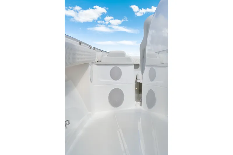Slide: The Image of Interior view of 2027 HCB 53 Suenos boat with sleek white design and speakers. - 56