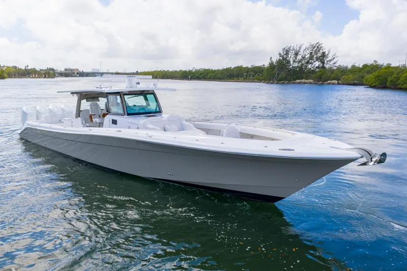 Slide: The Image of 2027 HCB 53 Suenos luxury boat cruising on a serene waterway. - 6