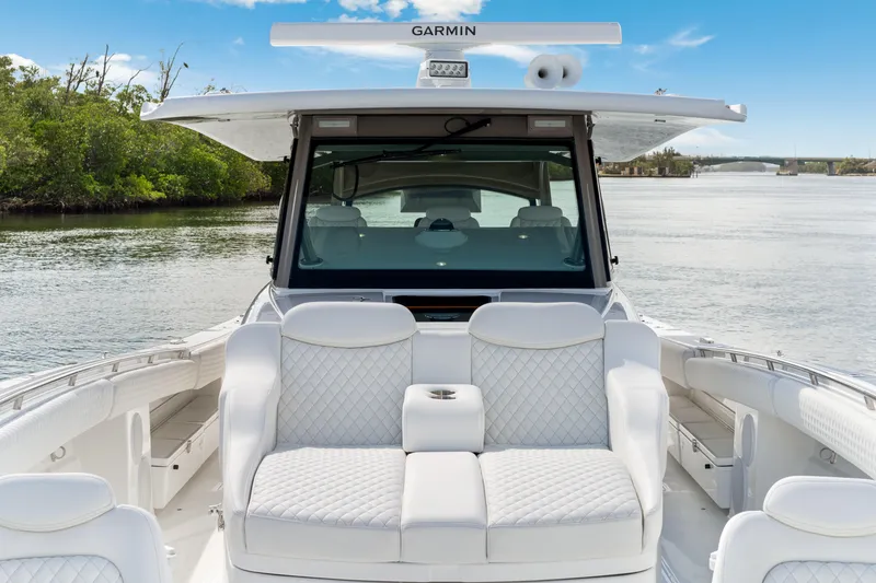 Slide: The Image of Luxurious 2027 HCB 53 Suenos boat interior with plush seating on a serene waterway. - 62