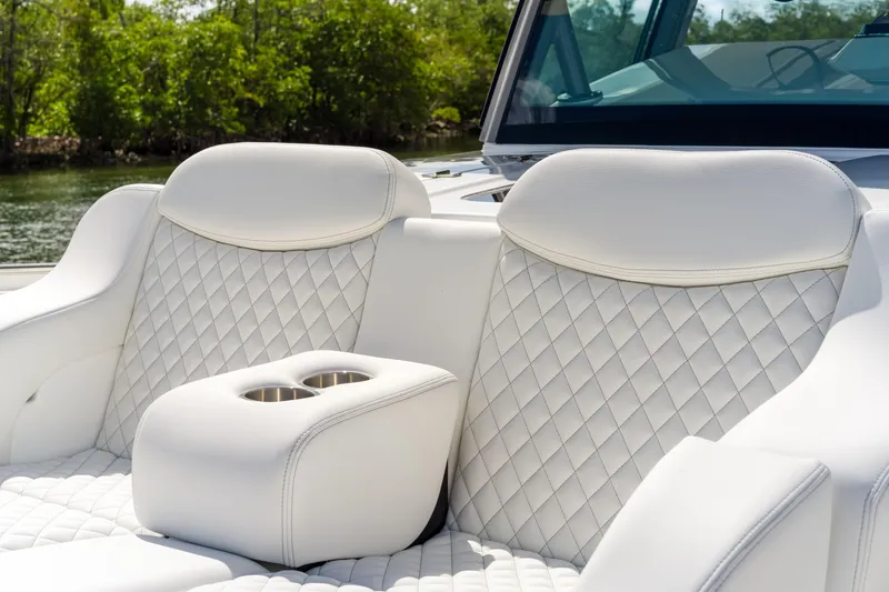 Slide: The Image of Luxurious white seating on 2027 HCB 53 Suenos boat with quilted design and cup holders. - 63