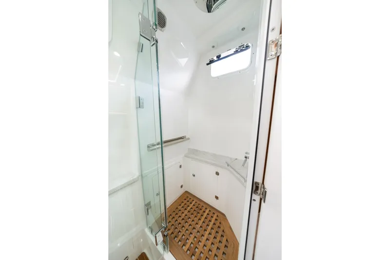 Slide: The Image of Luxurious shower area in 2027 HCB 53 Suenos yacht with glass door and wooden floor. - 65
