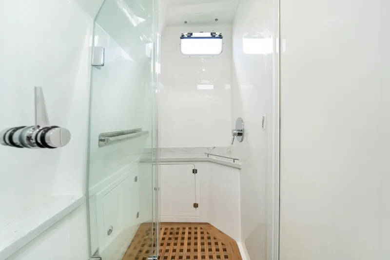 Slide: The Image of Luxurious shower area in 2027 HCB 53 Suenos yacht with glass door and wooden floor. - 66