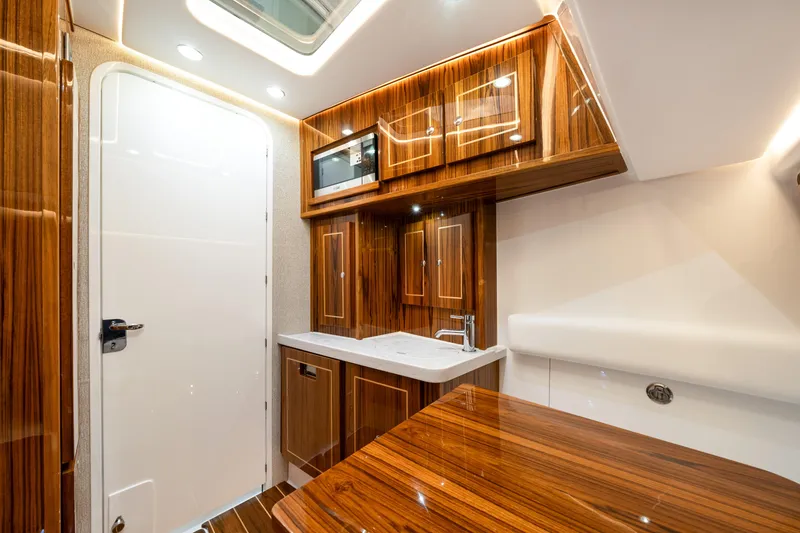 Slide: The Image of Luxurious interior of 2027 HCB 53 Suenos yacht featuring sleek wood cabinetry and modern amenities. - 71
