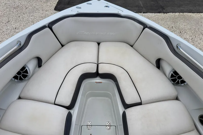 Slide: The Image of 2022 Crownline 260 XSS boat interior with cushioned seating and built-in speakers. - 10