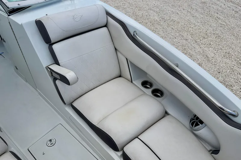 Slide: The Image of 2022 Crownline 260 XSS boat interior with cushioned seating and cup holders. - 12