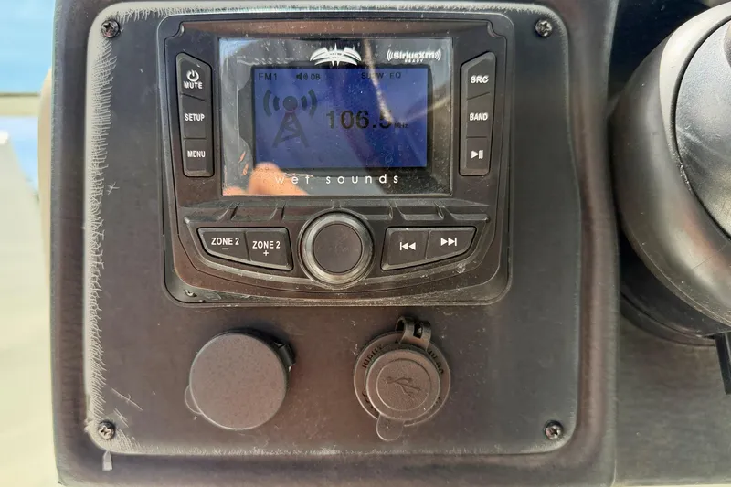 Slide: The Image of Close-up of a 2022 Crownline 260 XSS boat stereo system displaying FM radio. - 21