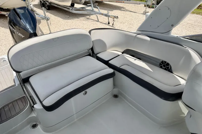 Slide: The Image of 2022 Crownline 260 XSS boat interior with white cushioned seating and sleek design. - 24
