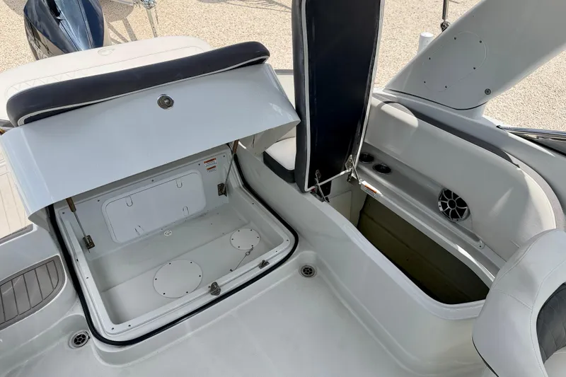 Slide: The Image of 2022 Crownline 260 XSS boat interior storage compartments and seating area. - 26