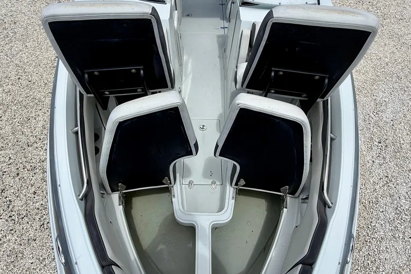 Slide: The Image of 2022 Crownline 260 XSS boat interior with open storage compartments, viewed from above. - 29