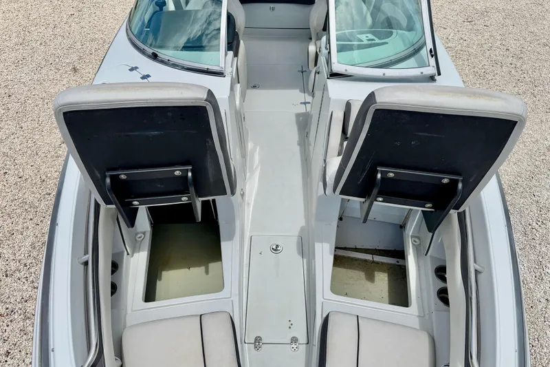 Slide: The Image of 2022 Crownline 260 XSS boat interior with open storage compartments and seating. - 30