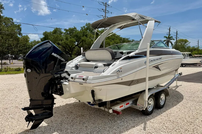 Slide: The Image of 2022 Crownline 260 XSS boat on trailer with Mercury outboard motor. - 5