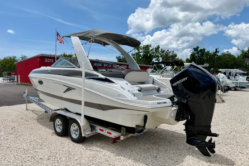 Slide: The Image of 2022 Crownline 260 XSS boat on trailer with Mercury outboard motor. - 7