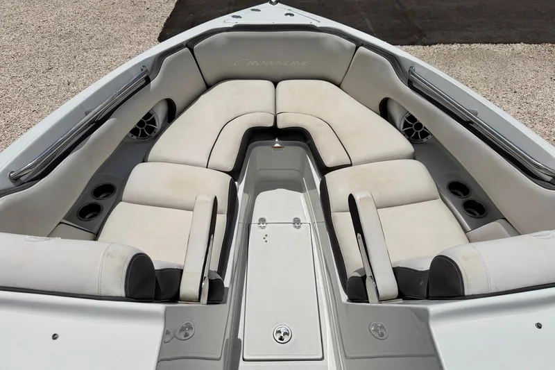 Slide: The Image of 2022 Crownline 260 XSS boat interior with plush seating and cup holders. - 9