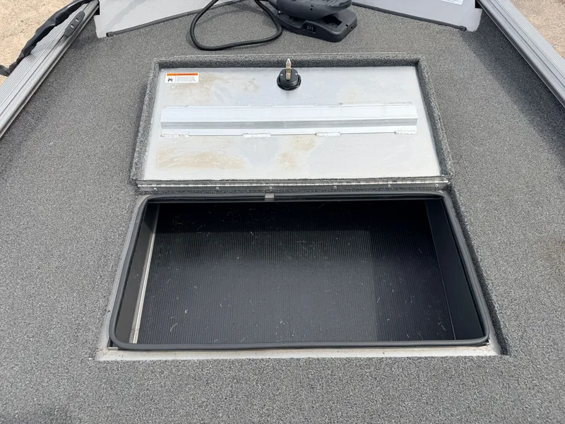 Slide: The Image of Crestliner 1700 Ridge boat 2021 with storage compartment open. - 13