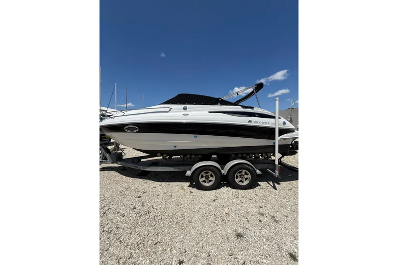 Slide: The Image of 2011 Crownline 236 SC boat on trailer under clear blue sky. - 10