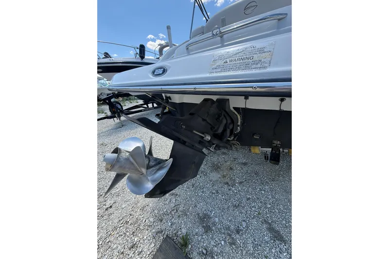 Slide: The Image of 2011 Crownline 236 SC boat stern with propeller on gravel surface. - 16