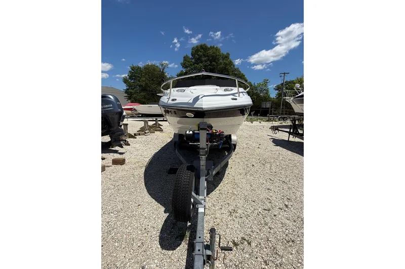 Slide: The Image of 2011 Crownline 236 SC boat on trailer under clear blue sky. - 2