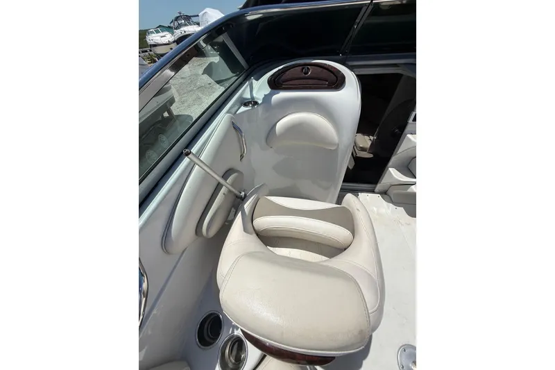Slide: The Image of 2011 Crownline 236 SC boat interior with white seating and control panel. - 20