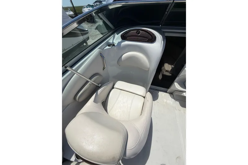 Slide: The Image of 2011 Crownline 236 SC boat interior with white seating and storage compartment. - 21