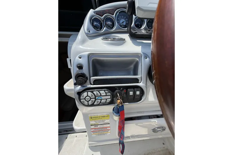 Slide: The Image of Dashboard of a 2011 Crownline 236 SC boat with gauges and controls. - 23